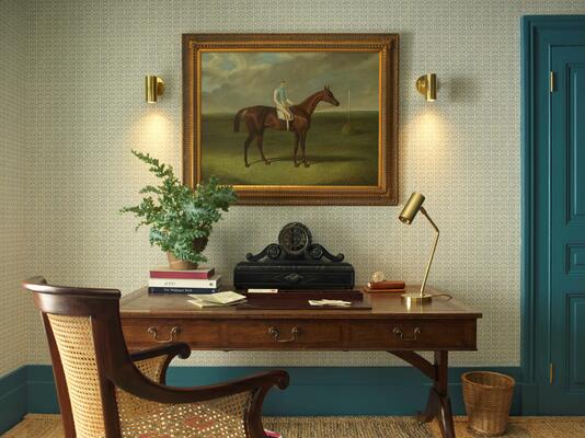 Langford wall light: Crafted from solid brass, the adjustable joint angles light effortlessly