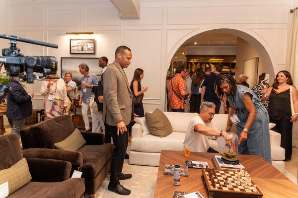 Attendees enjoy a first look at House of DuVäl furnishings in the Sherrill showroom