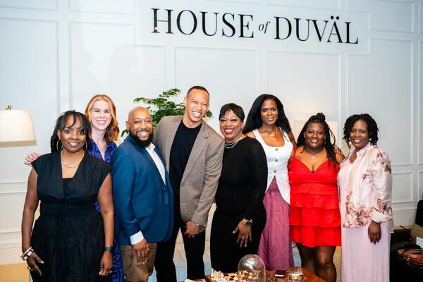Guests pose beneath the House of DuVäl logo at the brand’s launch event