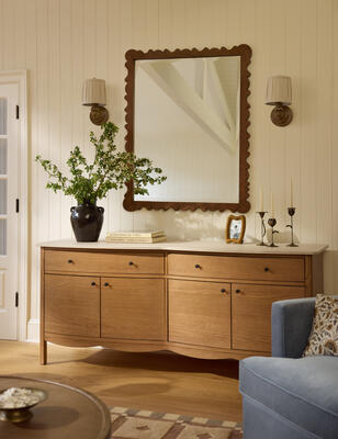 The Newburgh sideboard offers a sleek wood structure and a charming scalloped edge