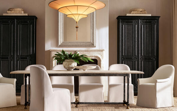 Baldacchino dining table in Emperador marble and turned steel, shown with Elle barrel-back dining chairs