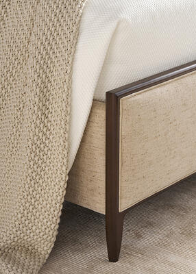 This fully upholstered bed from the Rendition collection features timeless tailoring and wood trim