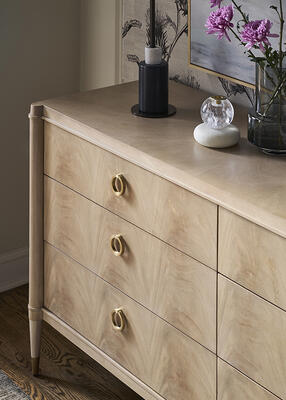 The Rendition dresser features metal hardware and ferrules finished in lacquered natural brass