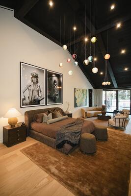 A diptych of large-scale black-and-white portraits adds personality to a serene bedroom