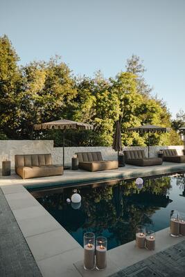 Arhaus outdoor furnishings line the pool
