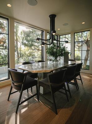 A chandelier by Entler Studio makes a modernist statement in the dining space