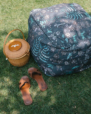 A pouf upholstered in fabric from The Vale London