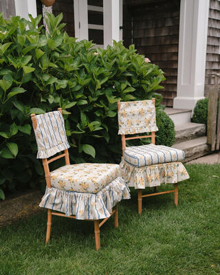 Bespoke ruffled slipcovers shown in Chintz Bouquet and Posey RicRac Stripe from The Keeping House