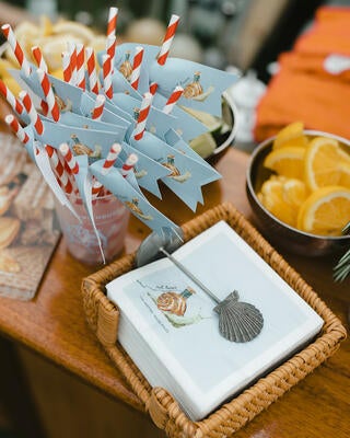 Custom napkins and straw flags invite guests to soak up the seaside vibes