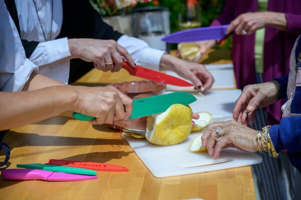 Guests prepare ingredients at the chef-led culinary experience, part of the afternoon’s interactive programming