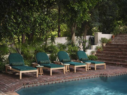 Club Stripe in Emerald with bolsters in Untamed bring the Trellis armless chaise to life
