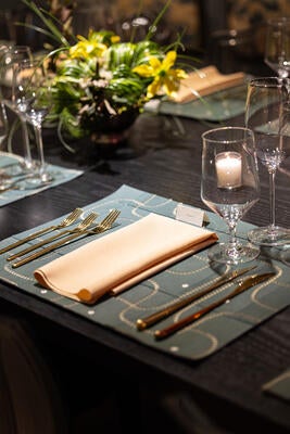 Arte’s embroidered leather wallcoverings were transformed into place mats