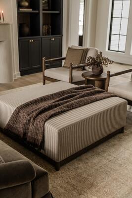 Steven square ottoman shown in the striped linen-blend fabric; available in other fabrics